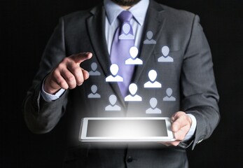 Man using a digital tablet with human icon