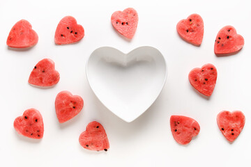 Obraz na płótnie Canvas Pattern of watermelon slices as hearts on white background. Flat lay. Valentine day. Copy space.