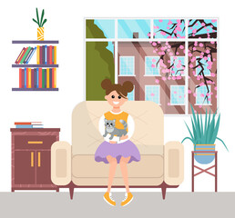 A young girl is resting with a gray cat sitting on her lap. A pet owner is stroking a small kitty. The child sits at home near the window against the background of sakura, playing with domestic animal