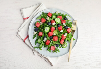 Delicious salad with watermelon served on white table, flat lay
