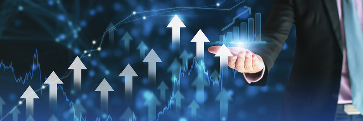 Businessman using holding symbol arrow up,stock graph and chart background,concept growth business and investment,Stock market and strategy for making market plan and stock market fluctuations