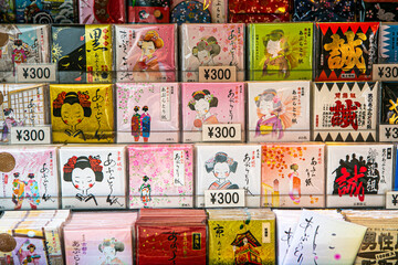 Paper napkins with japanese script and cartoons on sale in a store in Kyoto, japan