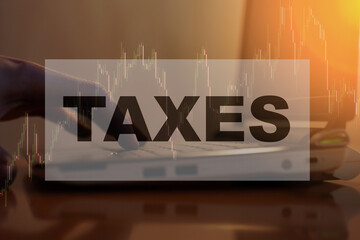 An adult calculates his TAXES on a computer at home in the evening.