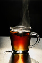 cup of hot tea on black table
