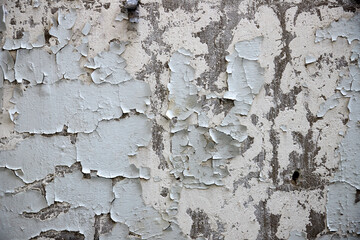texture of old wall with scuffed plaster and peeling of paint