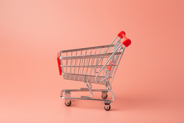 Trolley from the supermarket minimal on a colored background. Sales and purchases concept.
