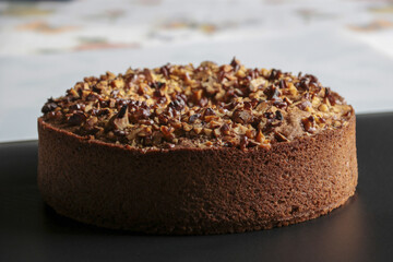 close up of nuts cake on black surface