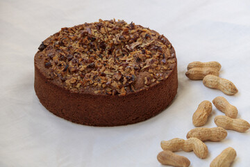  nuts and peanuts cake on a white linen table cloth