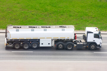 Fuel Truck Drives on the highway with a tank trailer.