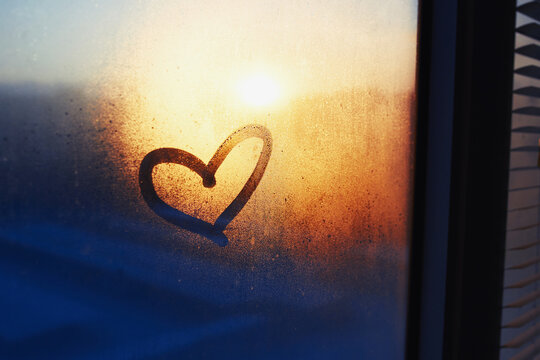 Heart drawn on a misty window