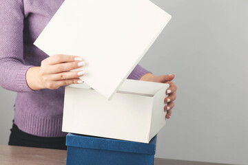 woman hand holding white box