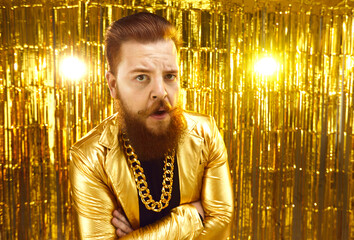 Portrait of eccentric man in extravagant disco party style jacket with gold chain around neck...