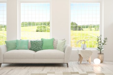 White living room with sofa and summer landscape in window. Scandinavian interior design. 3D illustration