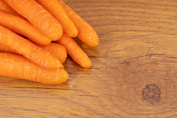 Carrots on a brown wooden background