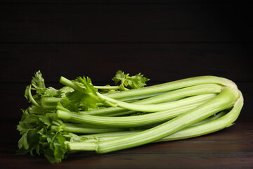 Fresh ripe green celery on wooden table