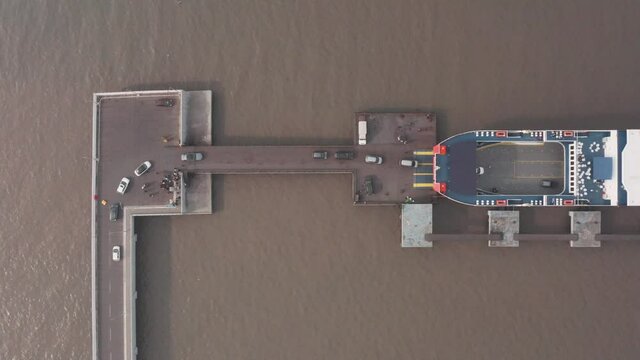 Top down drone shot of cars loading on to a car ferry