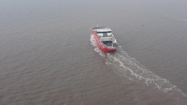 Rotating drone shot around red Mumbai Mandwa car ferry India