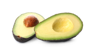 Cut ripe avocado with pit on white background