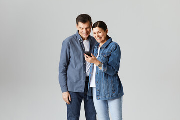 portrait of senor couple with a mobile phone in studio