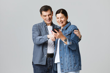 portrait of senor couple with a mobile phone in studio