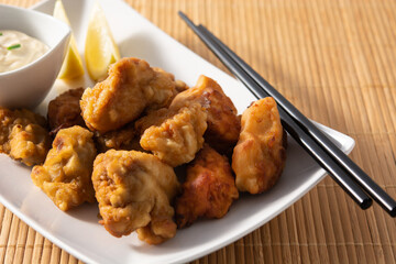 Spicy chicken karaage on black stone
