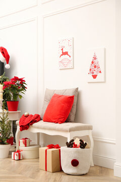 Christmas themed pictures in bright room with festive decorations. Interior design