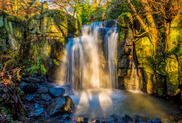 Fototapeta na wymiar A long exposure view of a stepped waterfall section at Lumsdale on Bentley Brook, Derbyshire, UK