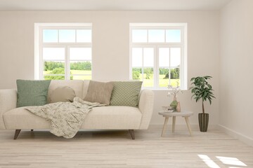 White living room with sofa and summer landscape in window. Scandinavian interior design. 3D illustration