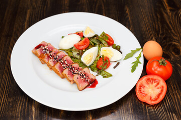Medium rear beef steak sliced and drizzled with sesame sauce