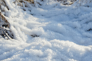Hoarfrost background texture. Fresh ice and snow winter backdrop with snowflakes and mounds. Seasonal wallpaper. Frozen water geometrical shapes and figures. Cold weather atmospheric precipitation.