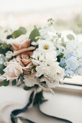 tender wedding bouquet on the table, white and cream roses
