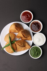 Kachori and samosa, Indian vegetarian snacks served with  green and tamarind chutneys.