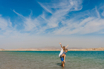 Happy couple posing at lake in desert of Ras Mohammed National Park. Egypt