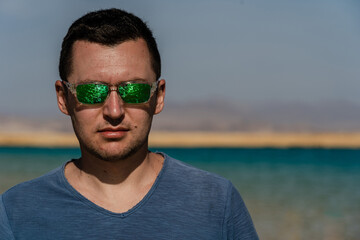 Man in sunglasses posing at lake in desert of Ras Mohammed National Park. Egypt