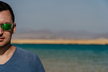 Man in sunglasses posing at lake in desert of Ras Mohammed National Park. Egypt