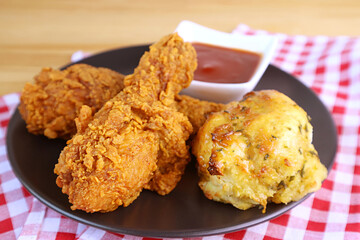 Plate of Golden Brown Crispy Fried Chicken Drumsticks with Garlic and Herb Biscuit