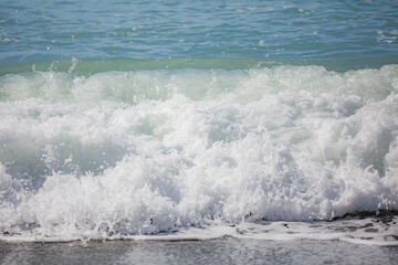 Blue sea water waves with white foam and bubbles. Winter see. Riva Trigoso on ligurian coast