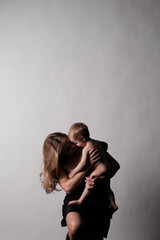 Mother with her little son. Grey background. Free copy space.