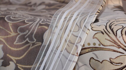 Tape and fabric for curtains close-up. Technological process of sewing curtains.