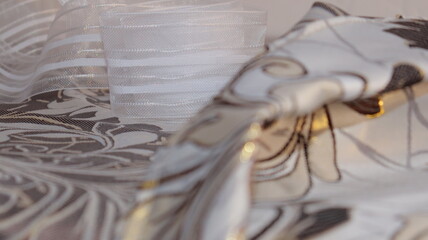 Tape and fabric for curtains close-up. Technological process of sewing curtains.