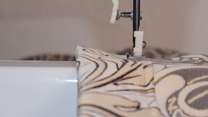 process of sewing curtains on the sewing machine. Sewing foot and needle close-up.