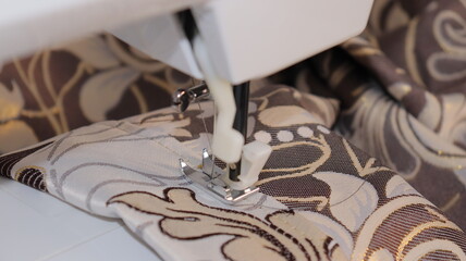 process of sewing curtains on the sewing machine. Sewing foot and needle close-up.