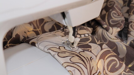 process of sewing curtains on the sewing machine. Sewing foot and needle close-up.