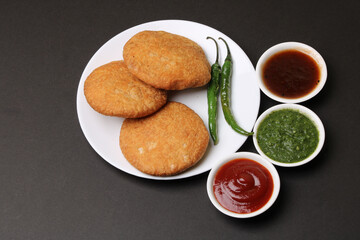 Indian snakes food kachouri or kachoudi kachori served with tamarind and mint chutney