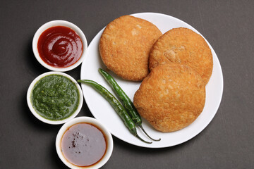 Indian snakes food kachouri or kachoudi kachori served with tamarind and mint chutney