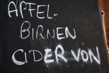 blackboard with handwritten words for apple, pear and cider in german langugae