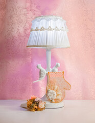 A vintage mramor lamp with the holiday card and decorative flowers bouqet are design for decoration of the girl's bedroom