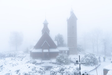 Kościół Wang Church in the town of Karpacz in southern Poland is a religious building brought from the Nordic countries as a gift to Poland. Picture with heavy fog and blizzard of snow and ice.