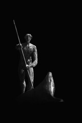 Charon transports the souls of dead people by boat across the Styx River in the underworld. Ancient statue.
