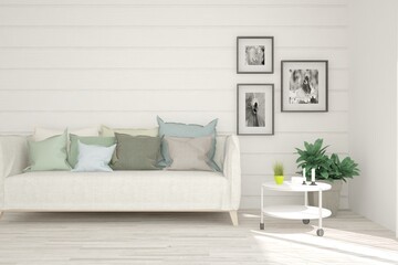 White living room with sofa, stylish table and green home plant. Scandinavian interior design. 3D illustration